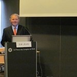 Dr. Glenn Jelks at lectern in Paris